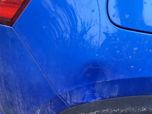 Blue car rear quarter panel before repair, shared by Jan Babycakes
